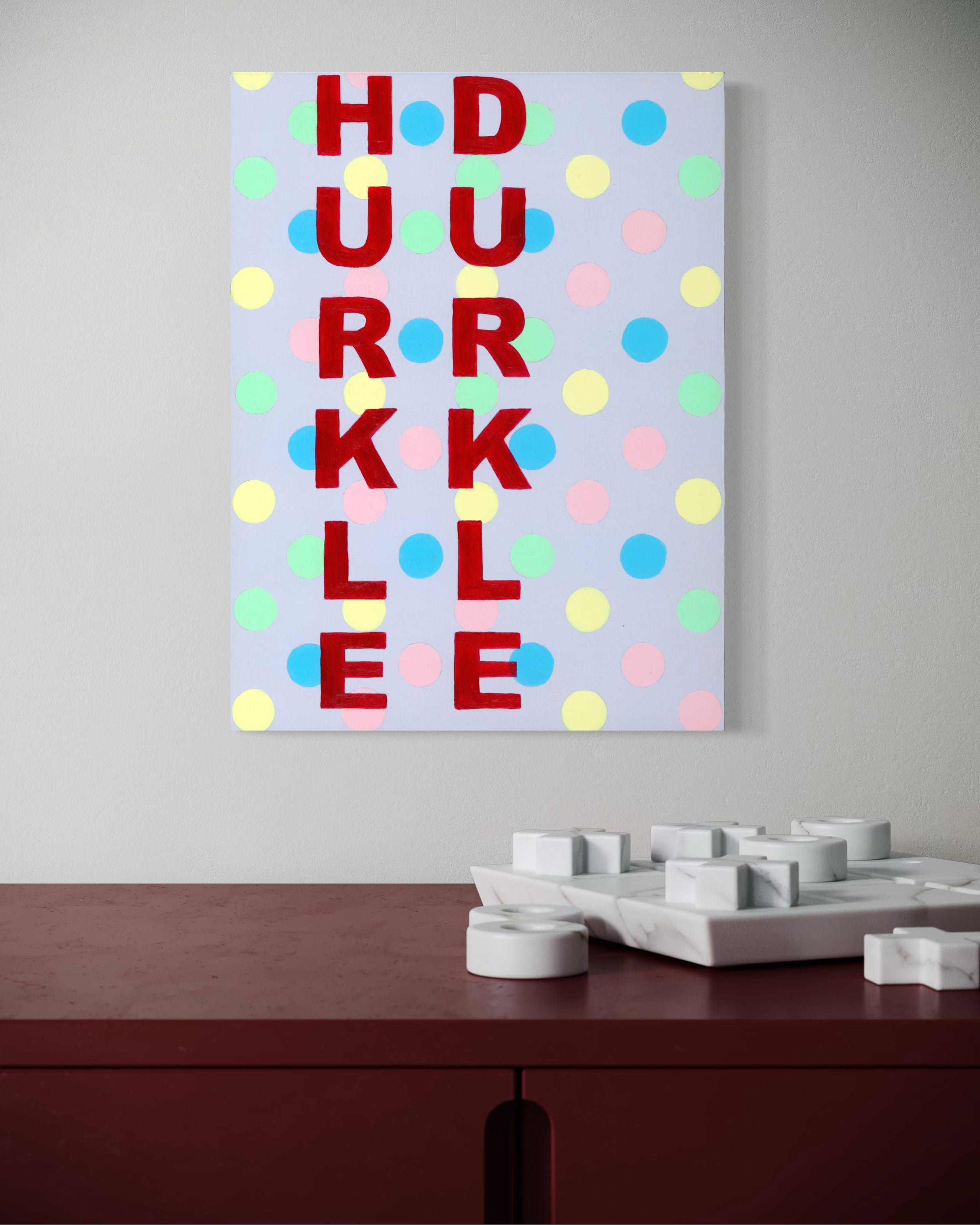 Bold red letters dance on a pastel polka dot background, creating a lively tapestry of text and colour.