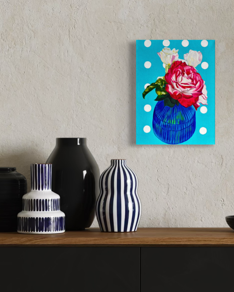 Original painting on canvas of a floral painting with a blue polka dot border on a wall above decorative vases.