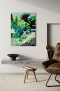 Modern interior with a painting of a tropical landscape, brown chair, and wooden stool.