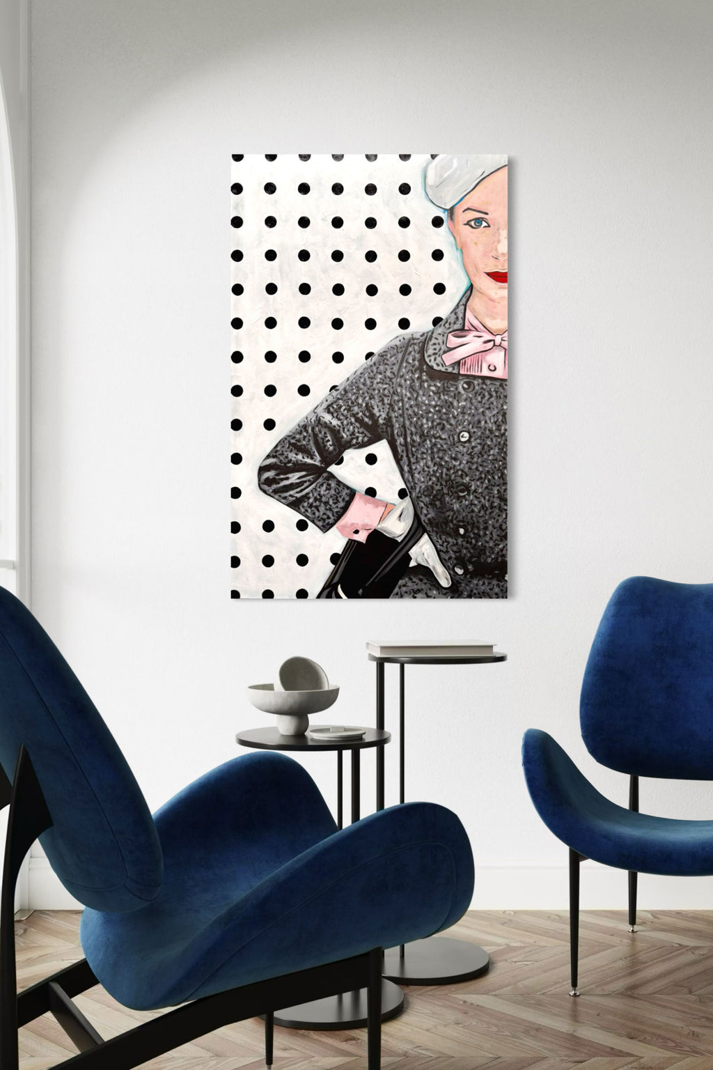 Modern interior with blue chairs and a stylish wall art piece, an original painting of a woman in a dress with a polka dot background. 