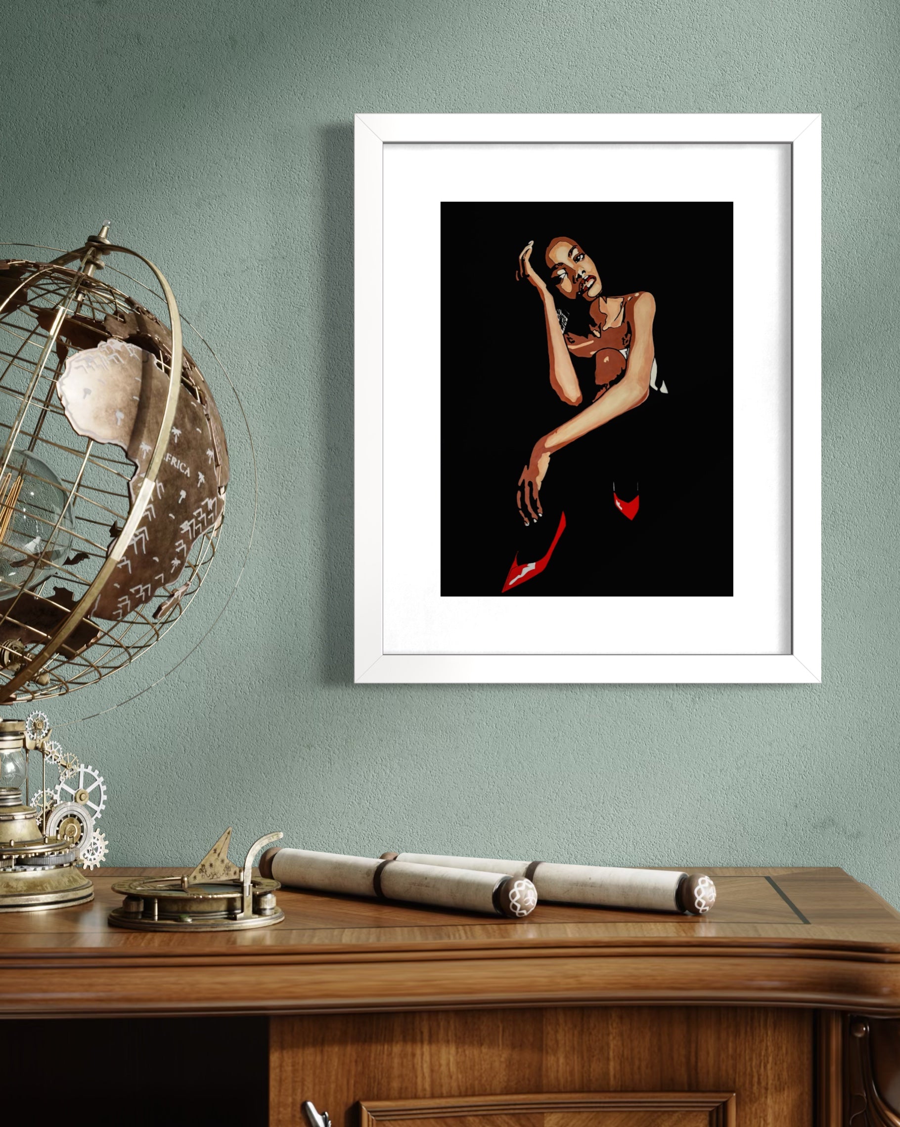 Framed artwork on a wall above a wooden desk with decorative items. Limited edition print by Annie Pritchard