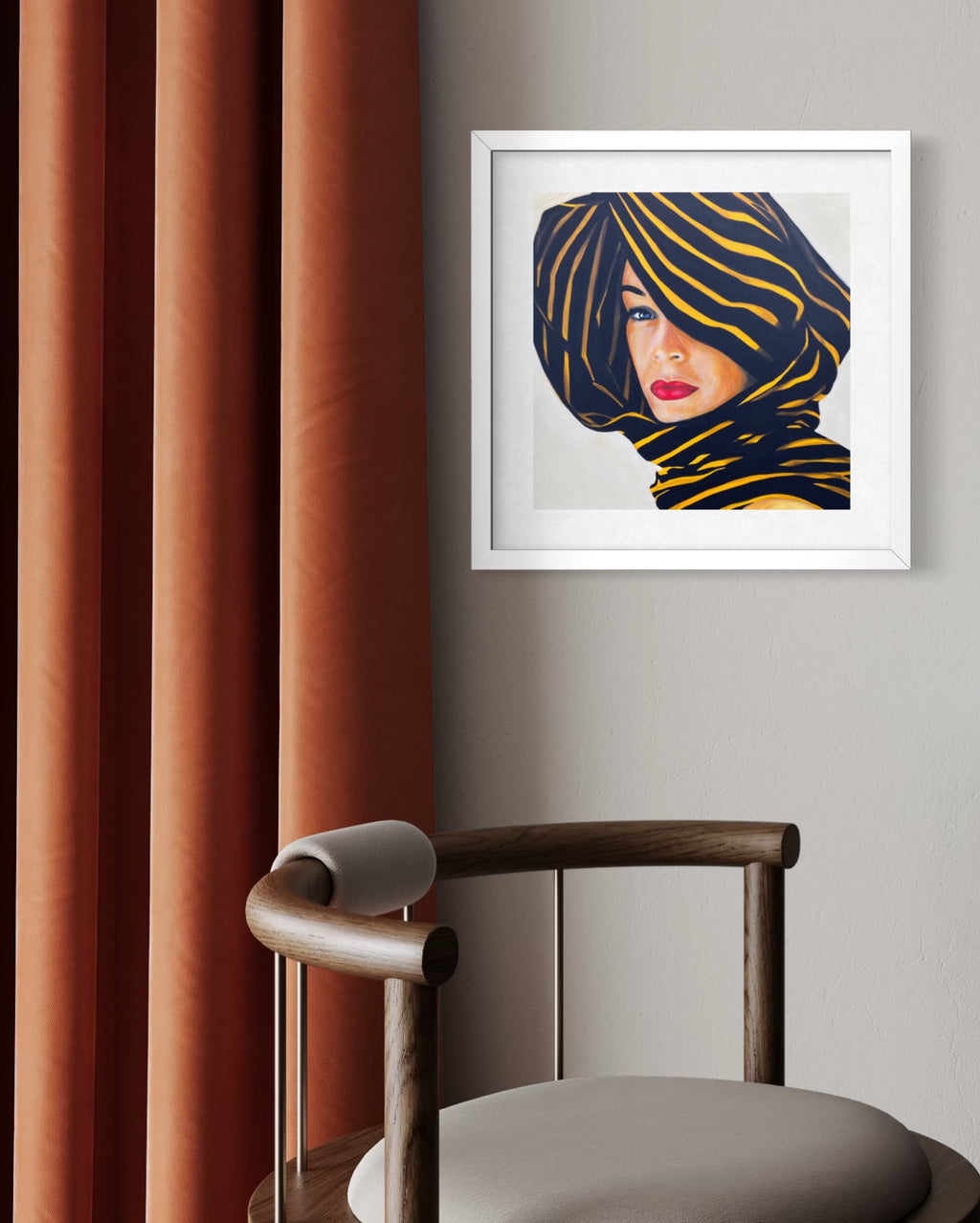 Framed limited edition print of a woman with a patterned headscarf on a gray wall next to a chair and red curtains.