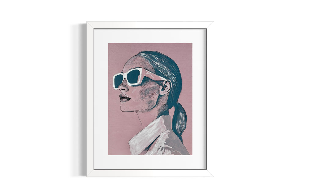 Framed artwork of a woman, 'Frankie', wearing sunglasses on a pink background