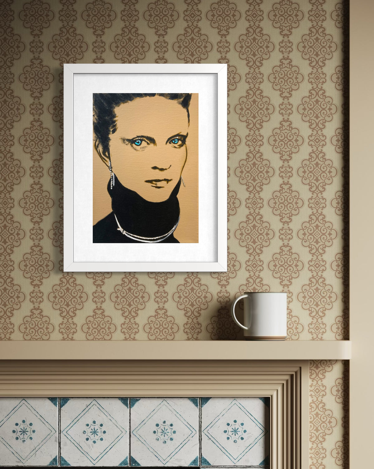 A framed pop-art portrait print of a woman with blue eyes and a black turtleneck, displayed on a beige patterned wallpaper wall above a mantel with a white mug nearby.