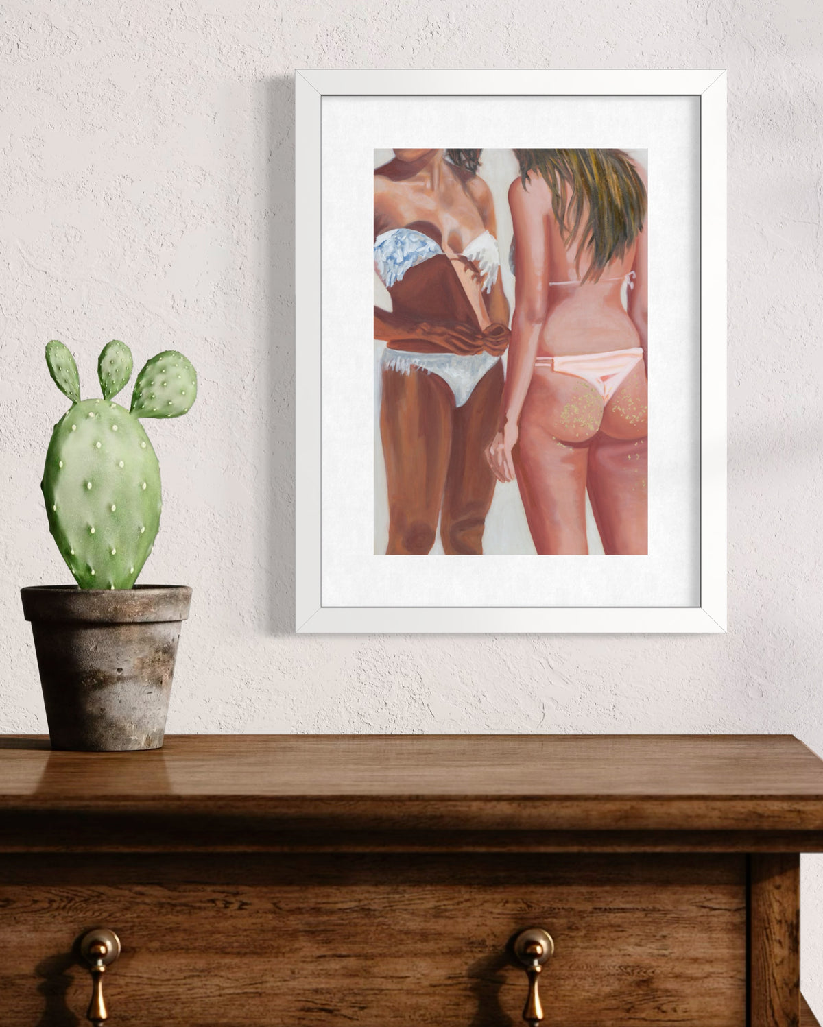 A print depicting two women in bikinis, shown from the back and side. The woman on the left wears a white bikini with blue patterned straps, while the woman on the right wears a pale pink bikini.