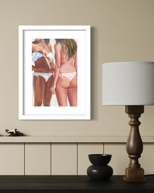 A print depicting two women in bikinis, shown from the back and side. The woman on the left wears a white bikini with blue patterned straps, while the woman on the right wears a pale pink bikini.