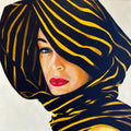 Artistic depiction of a woman's face with black and gold striped headscarf on a white background. Limited edition print by Annie Pritchard